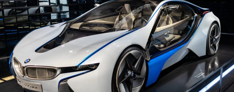 White luxury car parked in car dealership building