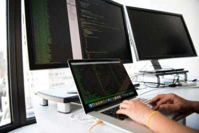 Close up photo of person typing on laptop. IT most highly paid sector in 2024, according to IrishJobs