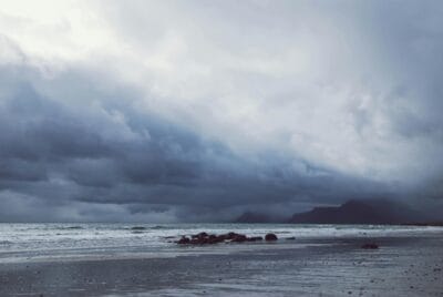 Ocean under gray cloudy sky. Homeowners Urged to Prepare for Powercuts Ahead of Storm Éowyn