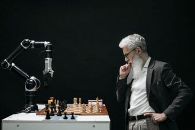 Elderly man thinking while looking at a chessboard. Free Public Lecture Series Explores Artificial Intelligence and Society